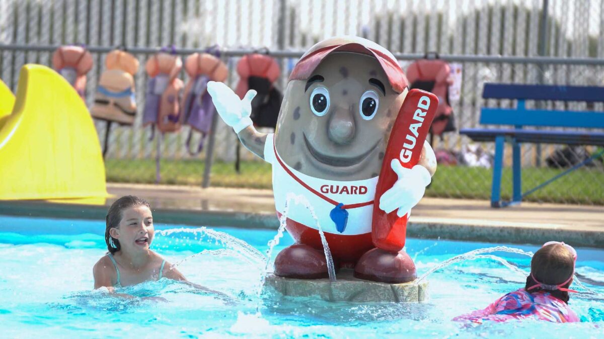 Pinto-MacBean_Bow-Island Bow Island pool swimmers around the mascot MacBean